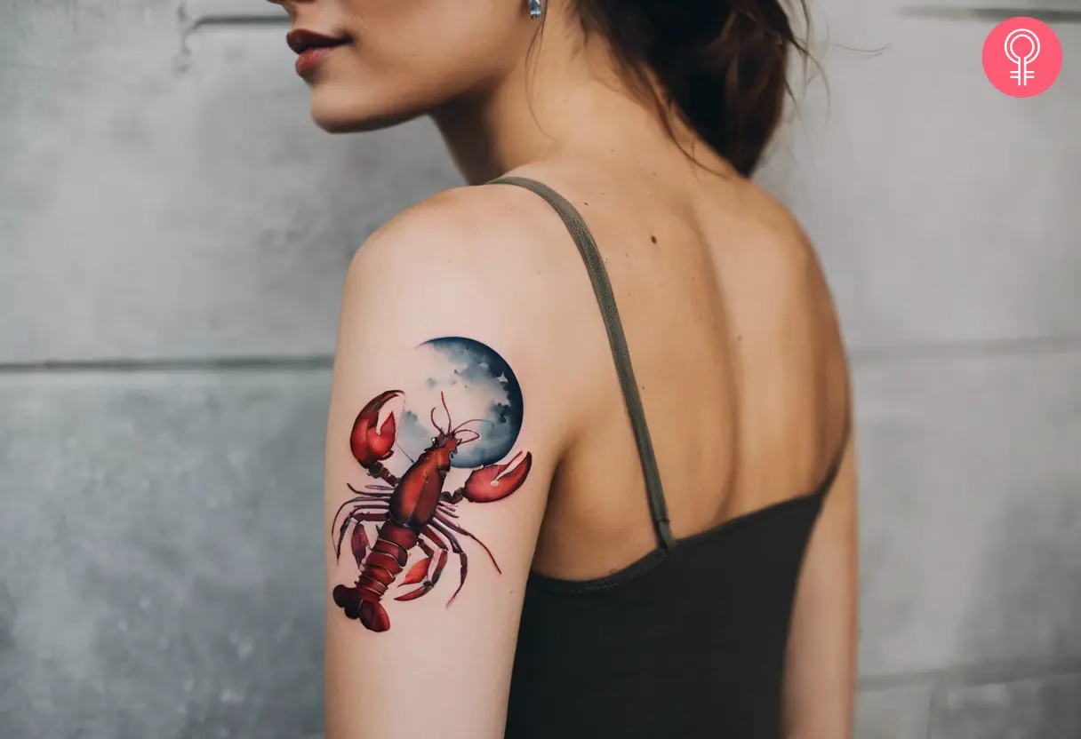 Feminine watercolor lobster tattoo on the upper arm