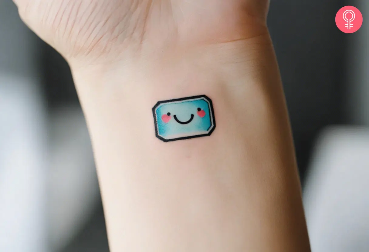 A woman wearing a Kawaii bandaid tattoo on her wrist