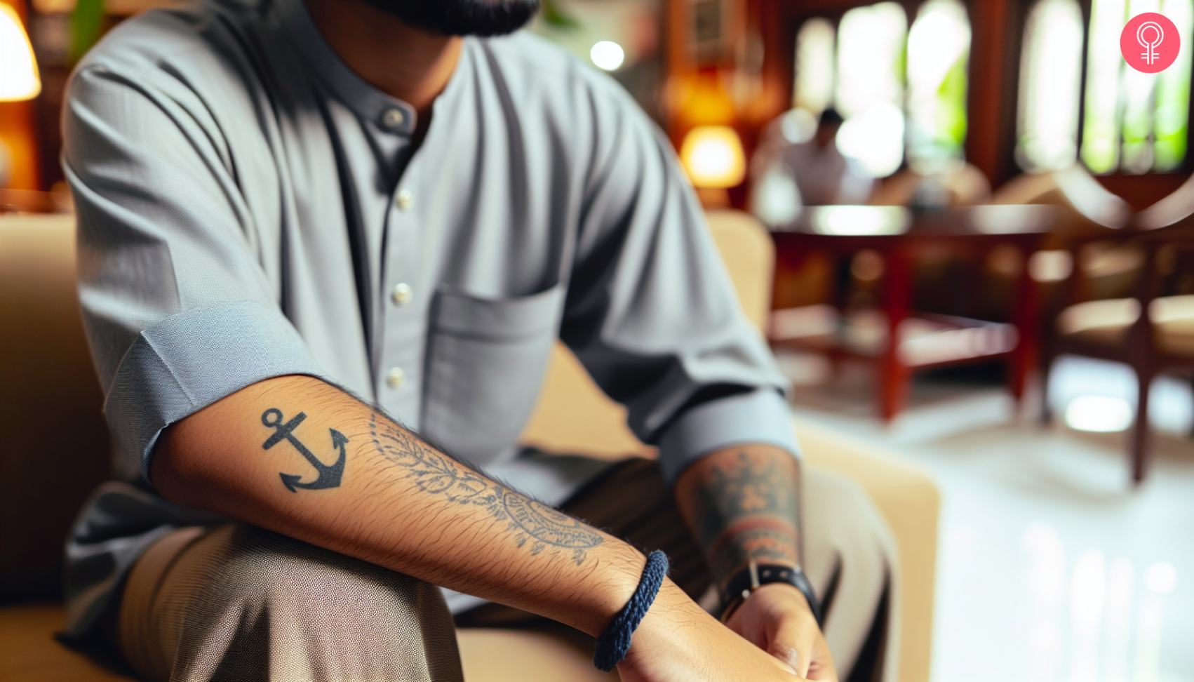 A simple anchor tattoo on the back of the forearm