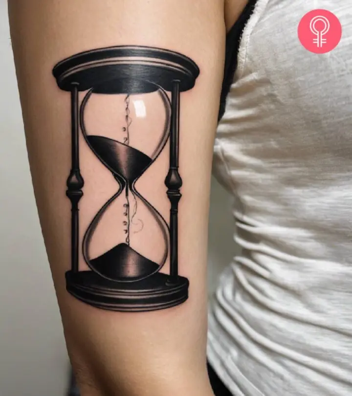 A woman flaunting an hourglass tattoo on her bicep