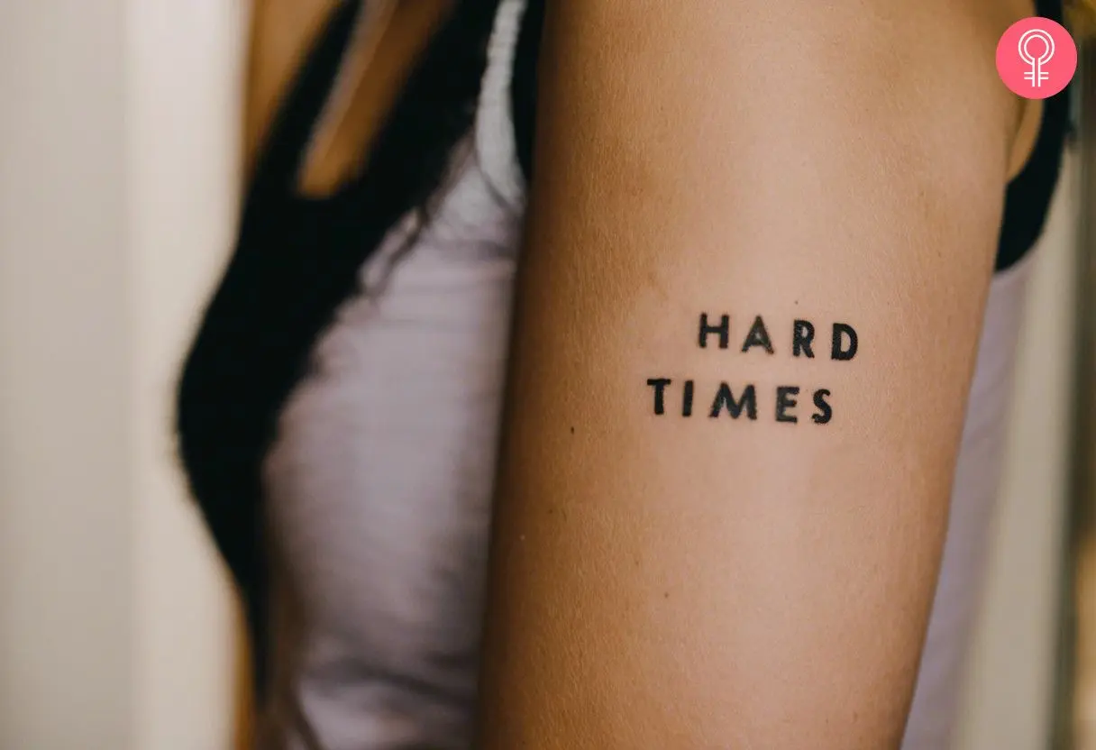 A woman with a “hard times” tattoo on her bicep