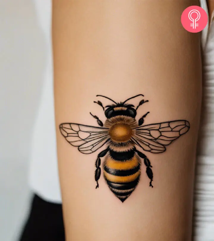 A woman with a honey bee tattoo on her upper arm