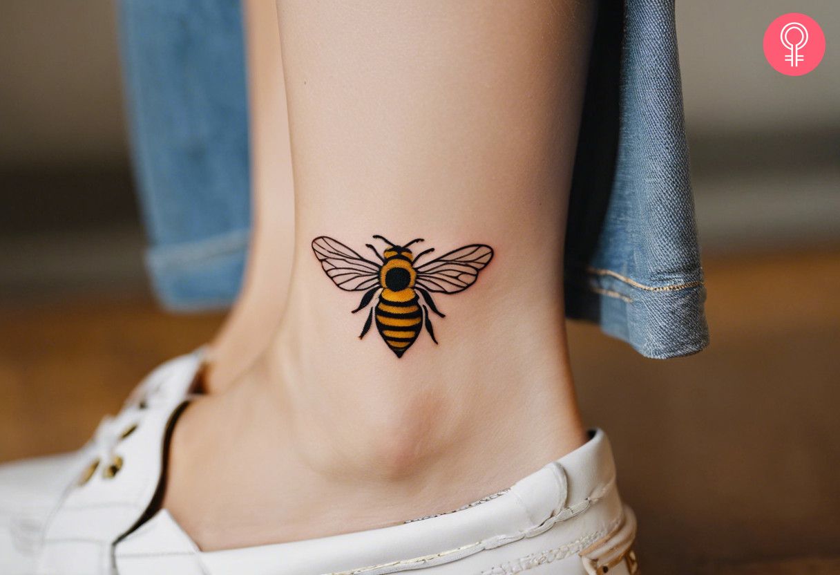 A woman with a minimalist honey bee tattoo on her ankle