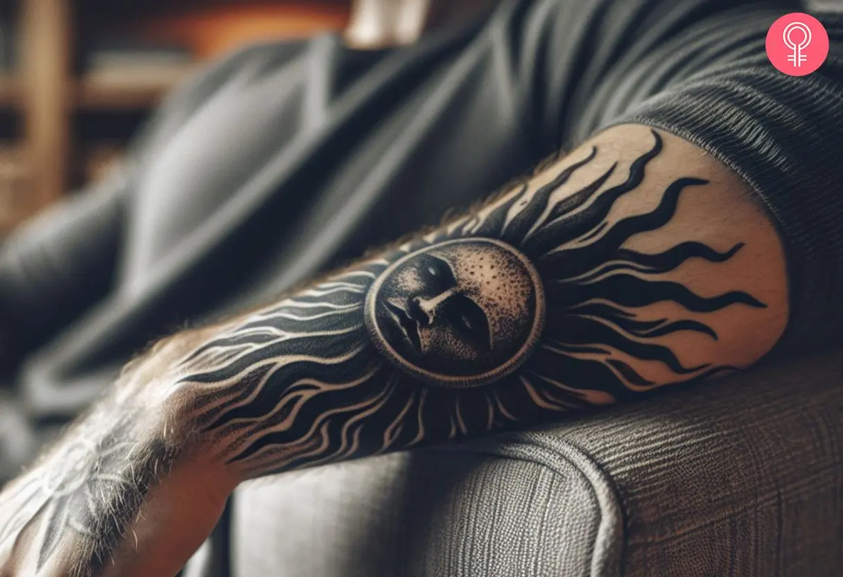 Black sun tattoo on the forearm