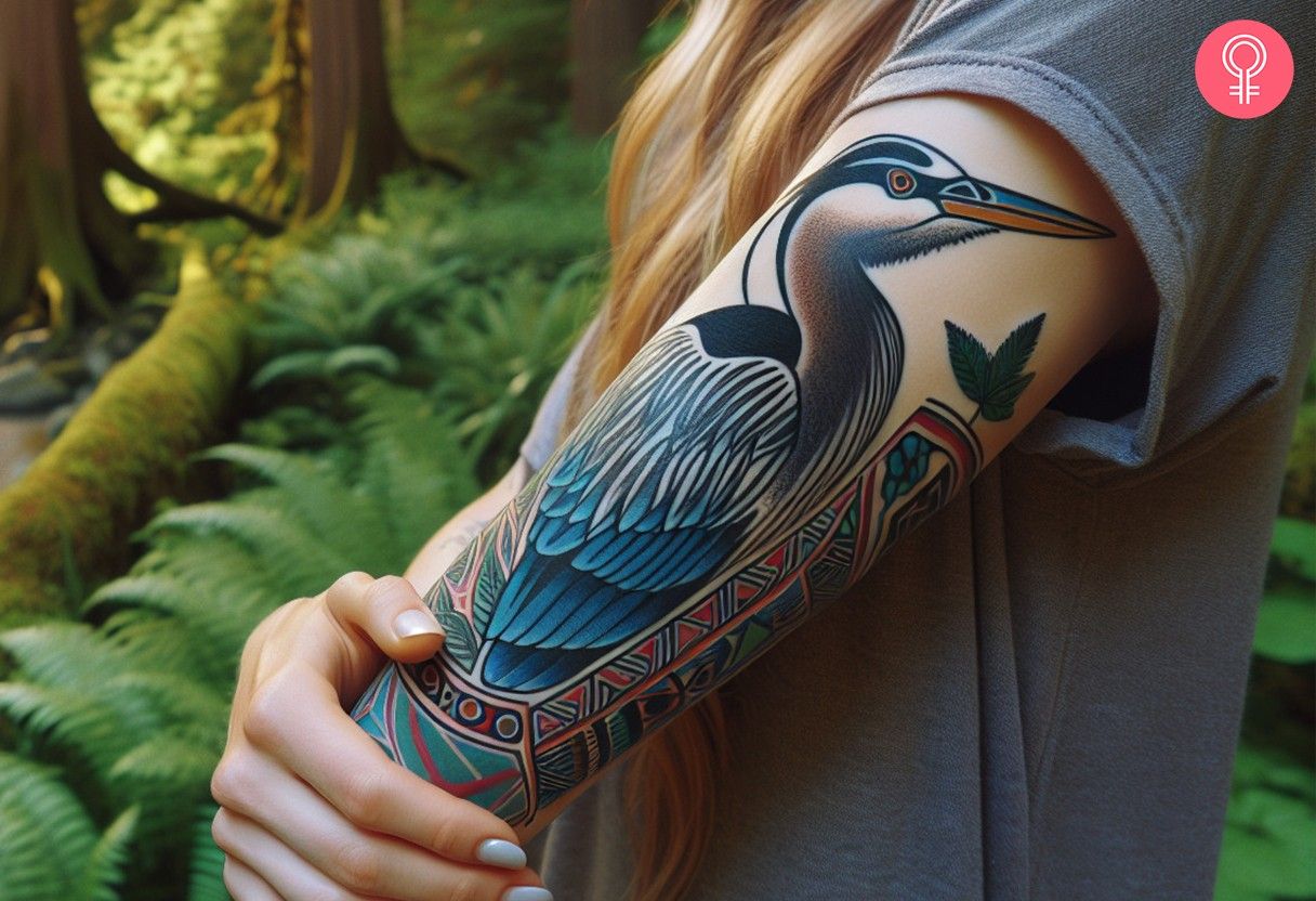 A woman with a colorful tattoo of a heron with geometric patterns