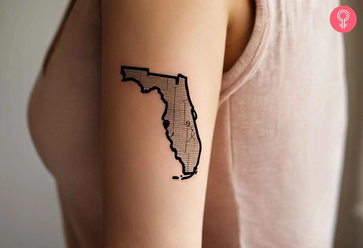 A woman with a Florida outline tattoo on her bicep