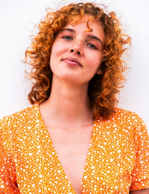 A woman with a curly shullet