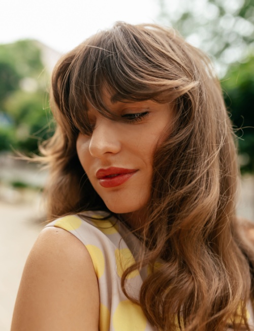  A woman sporting the soft shag with curtain bangs hairstyle