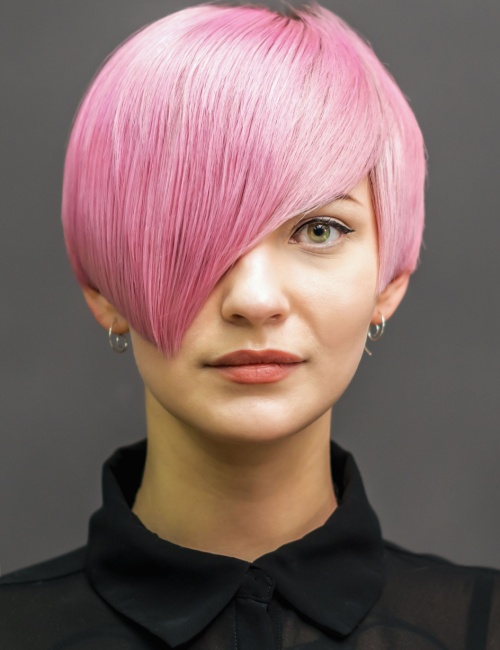 A woman with a pink asymmetrical pixie cut hairstyle