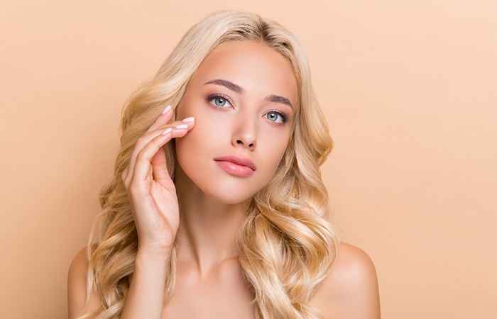 A woman with blonde hair and trendy beachy waves hairstyle