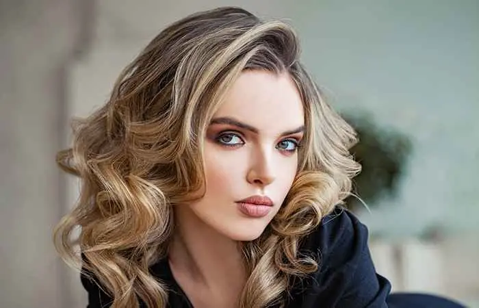 Woman with curly long layers and highlights