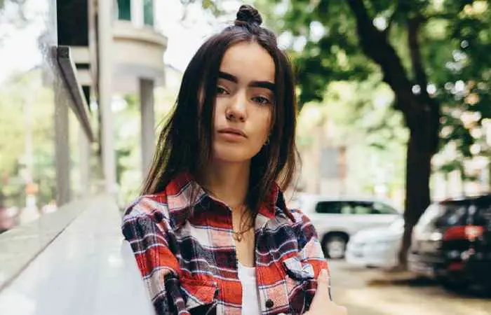 Woman with half top-knot and face-framing strands