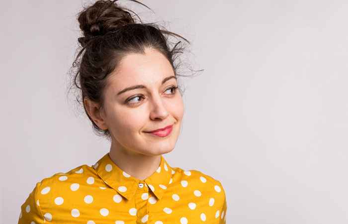 Woman with messy high bun hairstyle 