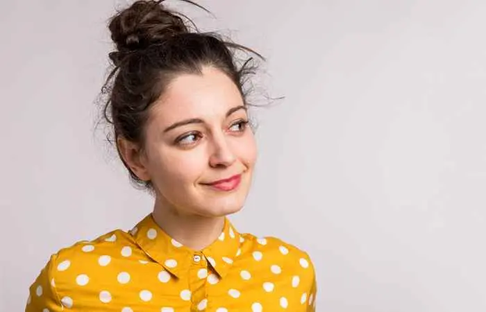 Woman with messy high bun hairstyle 