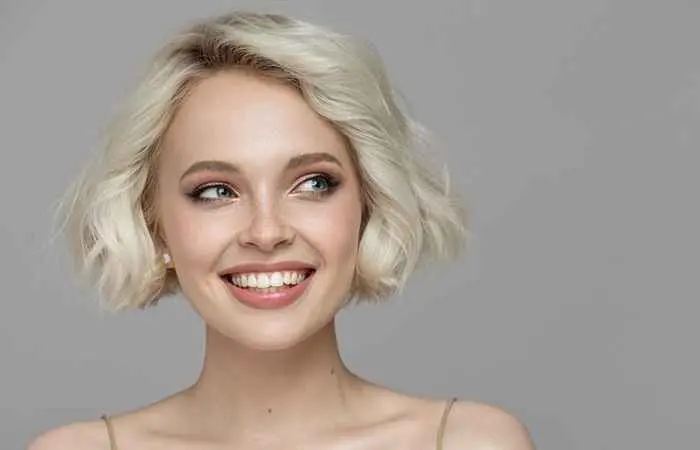 Woman with platinum blonde curly bob hairstyle
