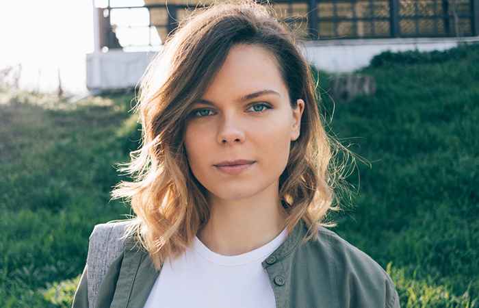 Woman with tousled wavy lob and side-swept bangs