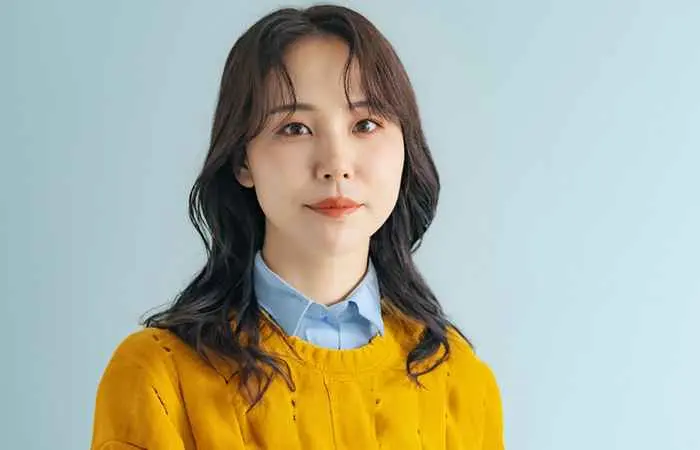 Asian woman with wispy bangs and mid-length layers