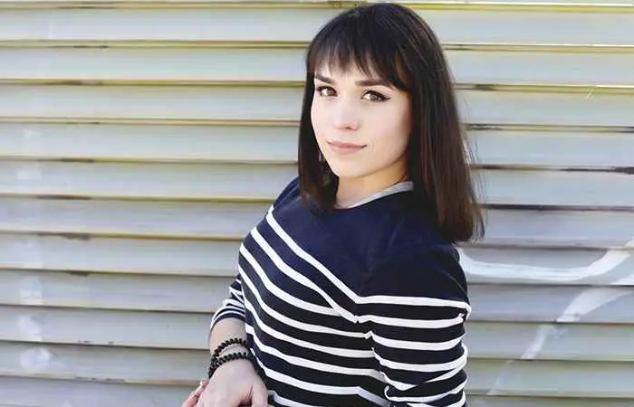 Woman with long bob hairstyle with thick wispy bangs